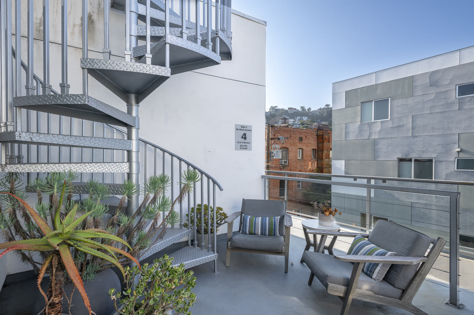 Rooftop terrace lounge with spiral stair